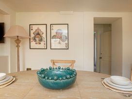 A dining room with a table and decorative items at Apartment 1, 86 Dyer Street Cirencester