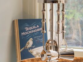 A bar tool set and cocktail book at Apartment 1, 86 Dyer Street, Cirencester
