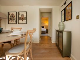 A dining room with a table set for dinner at Apartment 1, 86 Dyer Street Cirencester