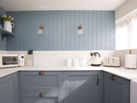 A kitchen with appliances on a counter at Apartment 1, 86 Dyer Street in Cirencester