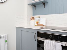 A kitchen with a countertop and various kitchen items at Apartment 1, 86 Dyer Street Cirencester