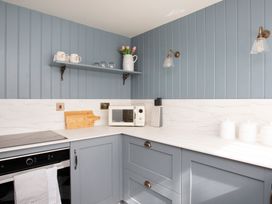 A kitchen with a countertop and shelf at Apartment 1, 86 Dyer Street Cirencester