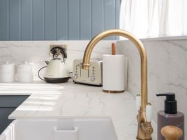 A kitchen counter with a kettle, toaster, and canisters at Apartment 1, 86 Dyer Street Cirencester