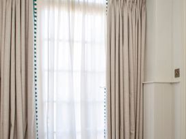 A window with curtains and sheer drapes at Apartment 1, 86 Dyer Street Cirencester
