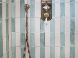 A shower control with tiles in a bathroom at Apartment 1, 86 Dyer Street Cirencester
