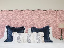 A bedroom with pillows on a bed at Apartment 1, 86 Dyer Street in Cirencester