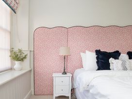 A bedroom with a bed and bedside lamp at Apartment 1, 86 Dyer Street Cirencester