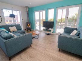 A living room with a sofa and coffee table at Lodge 83, Gwel an Mor, Portreath