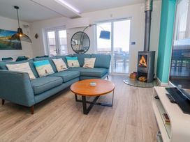 A living room with a sofa and coffee table at Lodge 83, Gwel an Mor in Portreath