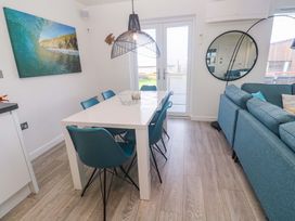 A dining room with a table and chairs at Lodge 83, Gwel an Mor, Portreath