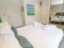 A bedroom with a bed and towels at Lodge 83, Gwel an Mor, Portreath