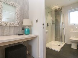 A bathroom with a shower and toilet at Lodge 83, Gwel an Mor Portreath
