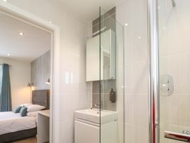 A bathroom with a shower and sink at Lodge 83, Gwel an Mor in Portreath