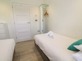 A bedroom with two beds and a towel at Lodge 83, Gwel an Mor, Portreath