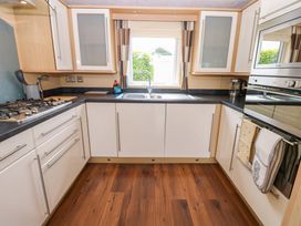 A kitchen with a sink and gas stove at Plot 12, Carlisle