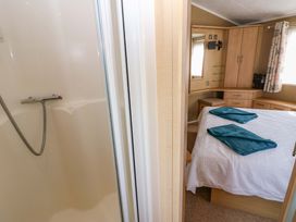 A bedroom with a shower and bed at Plot 12 in Carlisle