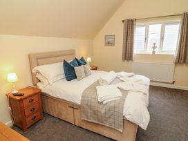 A bedroom with a double bed and bedside lamp at Lodge 7 in Brigg