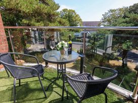 A balcony with a table and chairs at Apartment 11 in Poole