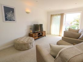 A living room with a sofa and television at Apartment 11 in Poole