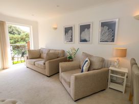 A living room with sofas and framed art at Apartment 11 in Poole