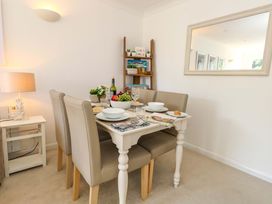 A dining room with a table set for a meal at Apartment 11 in Poole