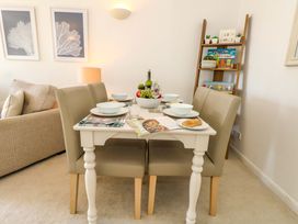 A dining room with a table set for a meal at Apartment 11 in Poole