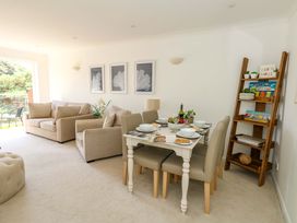 A living room with sofa and dining area at Apartment 11 in Poole