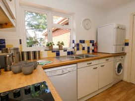 A kitchen with a sink and washing machine at Apartment 11 Poole