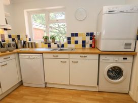 A kitchen with appliances and a sink at Apartment 11 in Poole