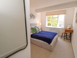 A bedroom with a bed and desk at Apartment 11 in Poole