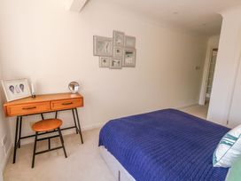 A bedroom with a bed and a desk at Apartment 11 in Poole