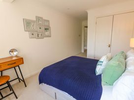 A bedroom with a bed and nightstand at Apartment 11 in Poole