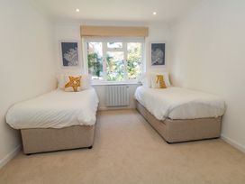 A bedroom with two single beds and a window at Apartment 11 in Poole