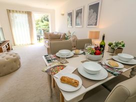 A dining room with a table set for a meal at Apartment 11 in Poole