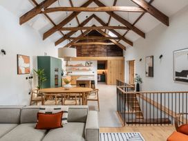 A living room with a dining area and kitchen in Lower Walreddon Farm Tavistock
