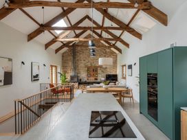A kitchen with a table and chairs at Lower Walreddon Farm Tavistock