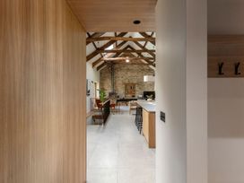 A kitchen with an island and stools at Lower Walreddon Farm Tavistock