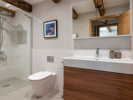 A bathroom with shower, toilet, and sink at Lower Walreddon Farm Tavistock