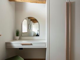 A bathroom with a mirror and a plant at Lower Walreddon Farm Tavistock