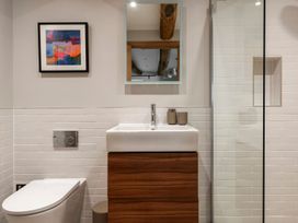 A bathroom with a sink, toilet, and shower at Lower Walreddon Farm in Tavistock
