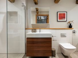 A bathroom with a sink and mirror at Lower Walreddon Farm in Tavistock
