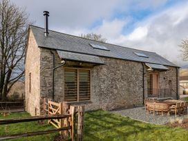 An exterior view of a house with a garden at Lower Walreddon Farm Tavistock
