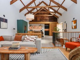 A living room with a sofa and coffee table at Lower Walreddon Barn in Tavistock