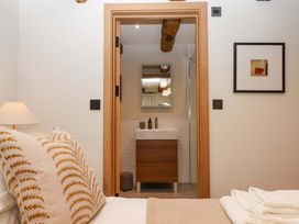 A bedroom with a view of the bathroom at Lower Walreddon Barn Tavistock