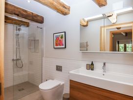 A bathroom with a shower, toilet, and sink at Lower Walreddon Barn in Tavistock
