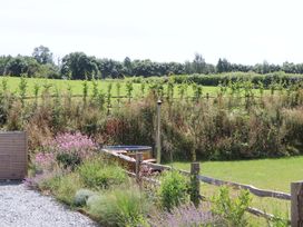 A garden with flowers and a hot tub at Lower Walreddon Barn Tavistock