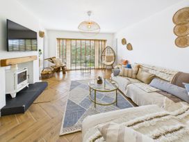 A living room with a television and sofa at 59a Gwscwm Road