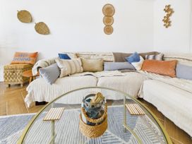 A living room with a sofa and coffee table at 59a Gwscwm Road