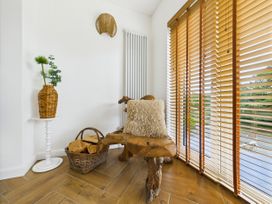An indoor space with a wooden bench and plant at 59a Gwscwm Road 