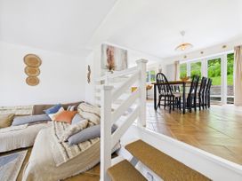 A dining room with a table and chairs at 59a Gwscwm Road 